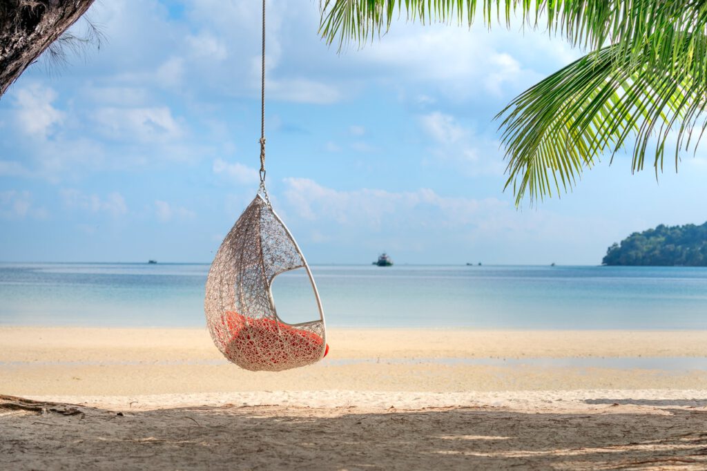 Wicker hanging chair hanging from the tree